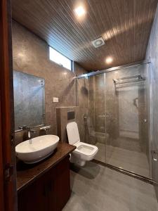a bathroom with a sink and a toilet and a shower at Emmonlang Resort and Restaurant in Dingpasoh +9 photos