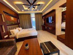 a hotel room with a bed and a couch at Emmonlang Resort and Restaurant in Dingpasoh