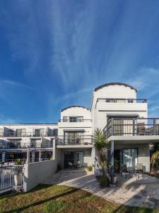 a large white building with a lot of windows at Corrigans Cove Resort Batemans Bay in Batemans Bay