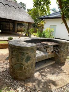 a stone bench in a yard with a building at Imani Guest House in Bulawayo