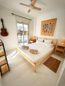 a bedroom with a large bed with a ceiling fan at Bungalow con Encanto in Torrevieja +64 photos