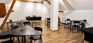 a room with tables and chairs and a piano at Centrum Rosenbaum in Beroun +14 photos