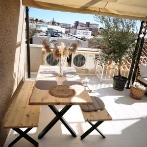 a table on a balcony with a view of a city at Bungalow con Encanto in Torrevieja