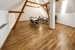 a room with tables and chairs in a loft at Centrum Rosenbaum in Beroun
