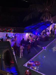 a group of people at a party by a pool at night at DE Lounge Inn in Ikorodu +69 photos