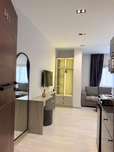 a kitchen and a living room with a couch at Regal view Aparthotel in Cairo