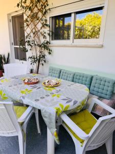a white table and chairs with plates of food on it at Lemon tree's house in Kalavárda