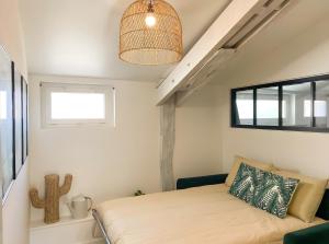 a small bedroom with a bed and a window at Le Logis de la Forge-10min puydufou in Mortagne-sur-Sèvre