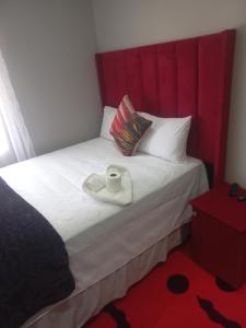 a bed with a roll of toilet paper on it at Tourist Guest House Accommodation in Mahikeng