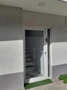 a door to a building with a staircase behind it at Haven Sierentz in Sierentz