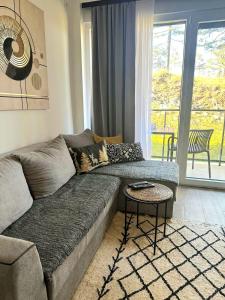 a living room with a couch and a table at Apartman Eden Divčibare in Divčibare