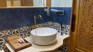a bathroom with a white sink on a counter at Suroor Houseboat in Srinagar +17 photos