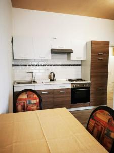 a kitchen with a table and a stove top oven at Hotel Art Balkanhof in Gelsenkirchen +32 photos
