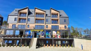 a building with a sign in front of it at Apartman Eden Divčibare in Divčibare