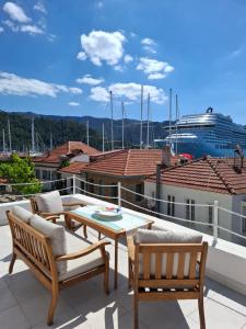 a balcony with a table and chairs and a cruise ship at Two Stone Homes Asteria in Marmaris