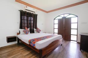a bedroom with a large bed in a room at Via Romeo's Stay - A Beach Property in Baga +31 photos