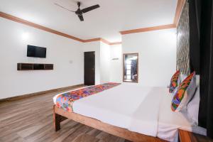 a bedroom with a bed and a tv on a wall at Via Romeo's Stay - A Beach Property in Baga