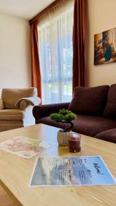 a living room with a table and a couch at студио Пирин in Razlog +6 photos