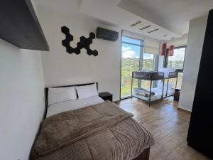 a bedroom with a bed and a balcony with a piano at Shams Farm in Ajloun