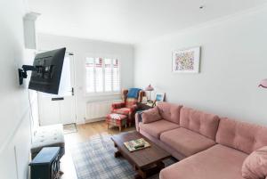 a living room with a couch and a table at Hidden Gem Townhouse - Cahersiveen in Cahersiveen