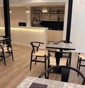 a restaurant with tables and chairs and a counter at Hulot B&B Valencia in Valencia