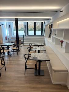 a group of tables and chairs in a room at Hulot B&B Valencia in Valencia