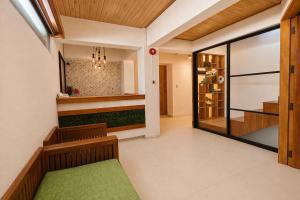 a corridor of a house with a green bench at Taj Resort and Spa in Boracay