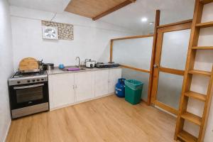 a kitchen with white cabinets and a stove top oven at Taj Resort and Spa in Boracay