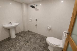 a bathroom with a toilet and a sink at Taj Resort and Spa in Boracay +33 photos