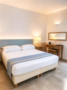 a bedroom with a large bed and a table at Hotel Guarracino in Capri