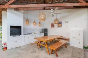a kitchen with a wooden table and a ceiling fan at Blauset Two in General Luna