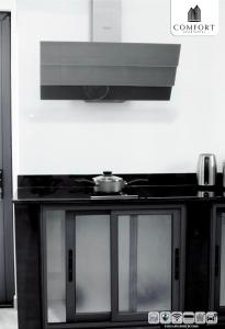 a black cabinet with a tv on top of it at Comfort Aparthotel in Chimoio