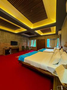 a bedroom with a large bed with a red carpet at Olive in Tāla
