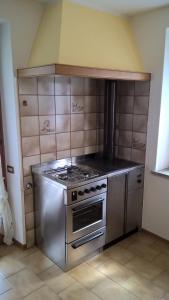a kitchen with a stainless steel stove top oven at Appartamenti Fabila in Castello Tesino