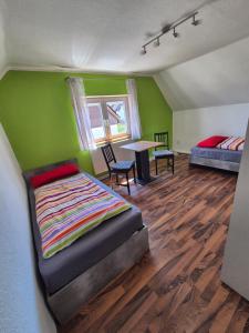 a bedroom with a bed and a table in it at Zimmervermietung Müller in Kelheim