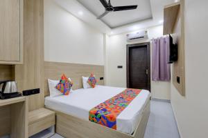 a bedroom with a bed and a television in it at FabHotel Shivangan in Vrindāvan +20 photos