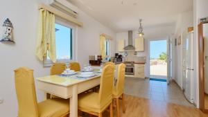 a kitchen and dining room with a table and chairs at House Vissum by Villas Guide in Lukovo