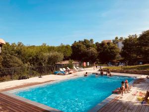 a group of people sitting in a swimming pool at Lodges du Ushuaïa Villages Camping les 4 Saisons in Grane