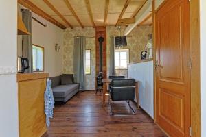 a kitchen and living room with a couch and a table at Le Chêne d’Or in Marcheseuil