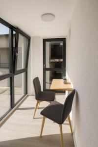 a room with a table and two chairs and a window at Tibetan BB in Bellinzona