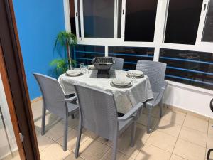 a dining table and chairs in a room with a window at Cabo Dream 51 in Cabo Negro