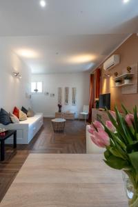 a living room with a white couch and a table at Gold Apartment in Ferrara
