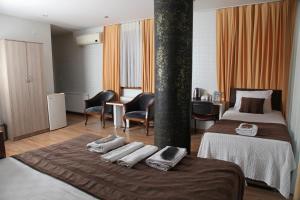 a hotel room with a bed with towels on it at garden hill hotel in Istanbul