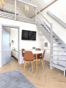 a dining room with a table and chairs and a staircase at #MazuryOFFline in Giżycko