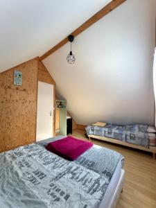 a bedroom with a large bed in a attic at Gîte EAU'DER in Giffaumont-Champaubert