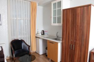 a kitchen with a sink and a desk and a chair at garden hill hotel in Istanbul +83 photos