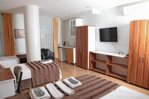 a hotel room with a bed and a desk and a tv at garden hill hotel in Istanbul