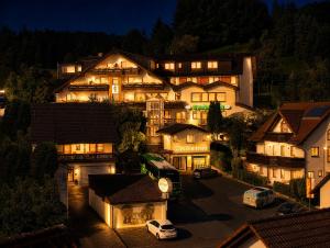 a large house with lights on at night at Landhotel Spessartruh in Frammersbach