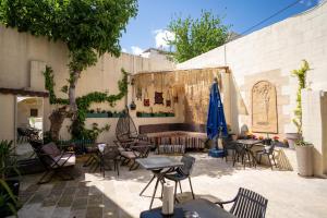 a patio with chairs and tables and umbrellas at sermest house in Urfa