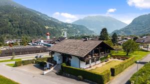 a house in a village with mountains in the background at Chalet Bodenschatz in Vandans